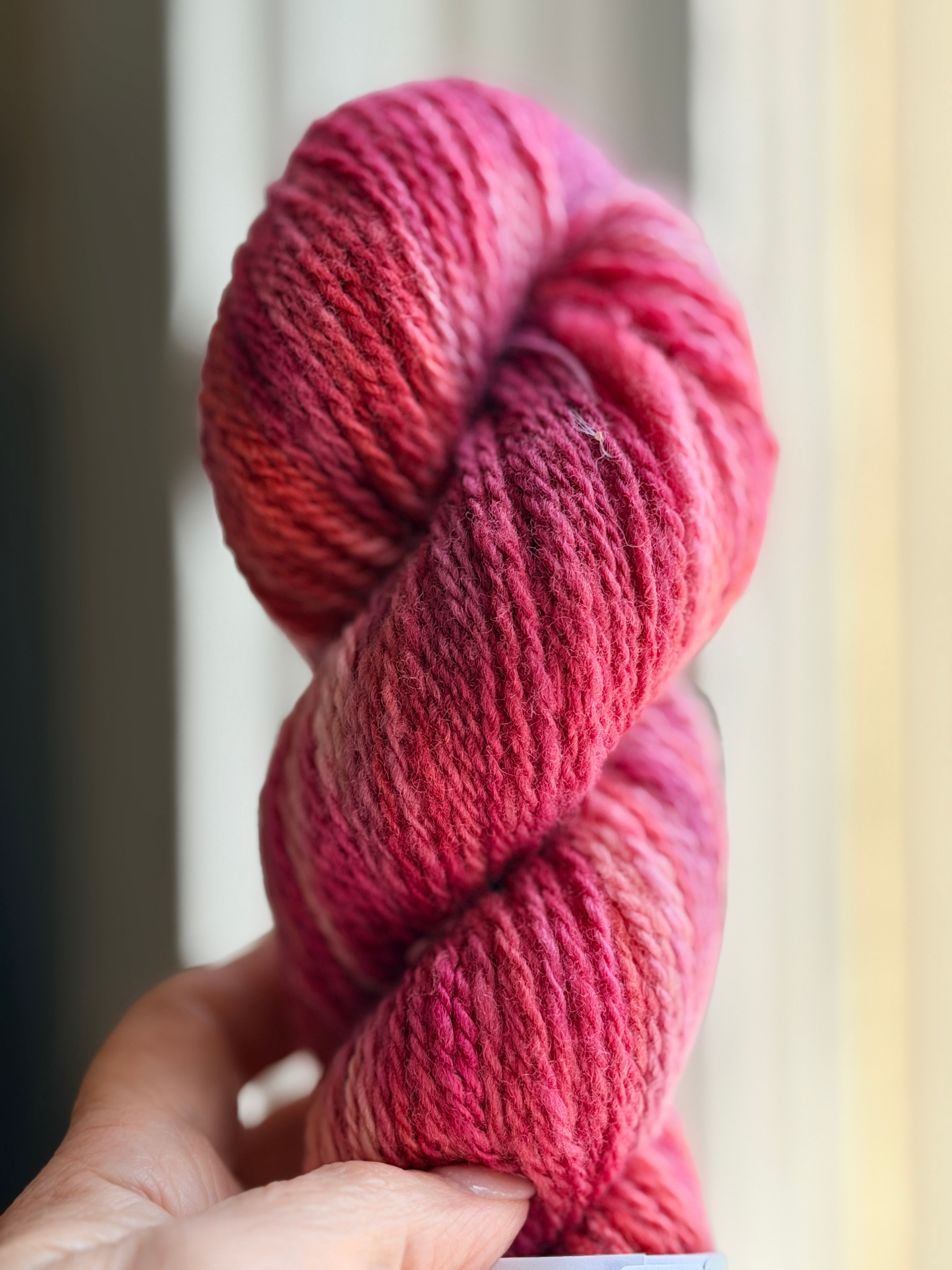 Red pink yarn in natural light