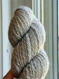 Close up picture of a skein of natural color yarn.
