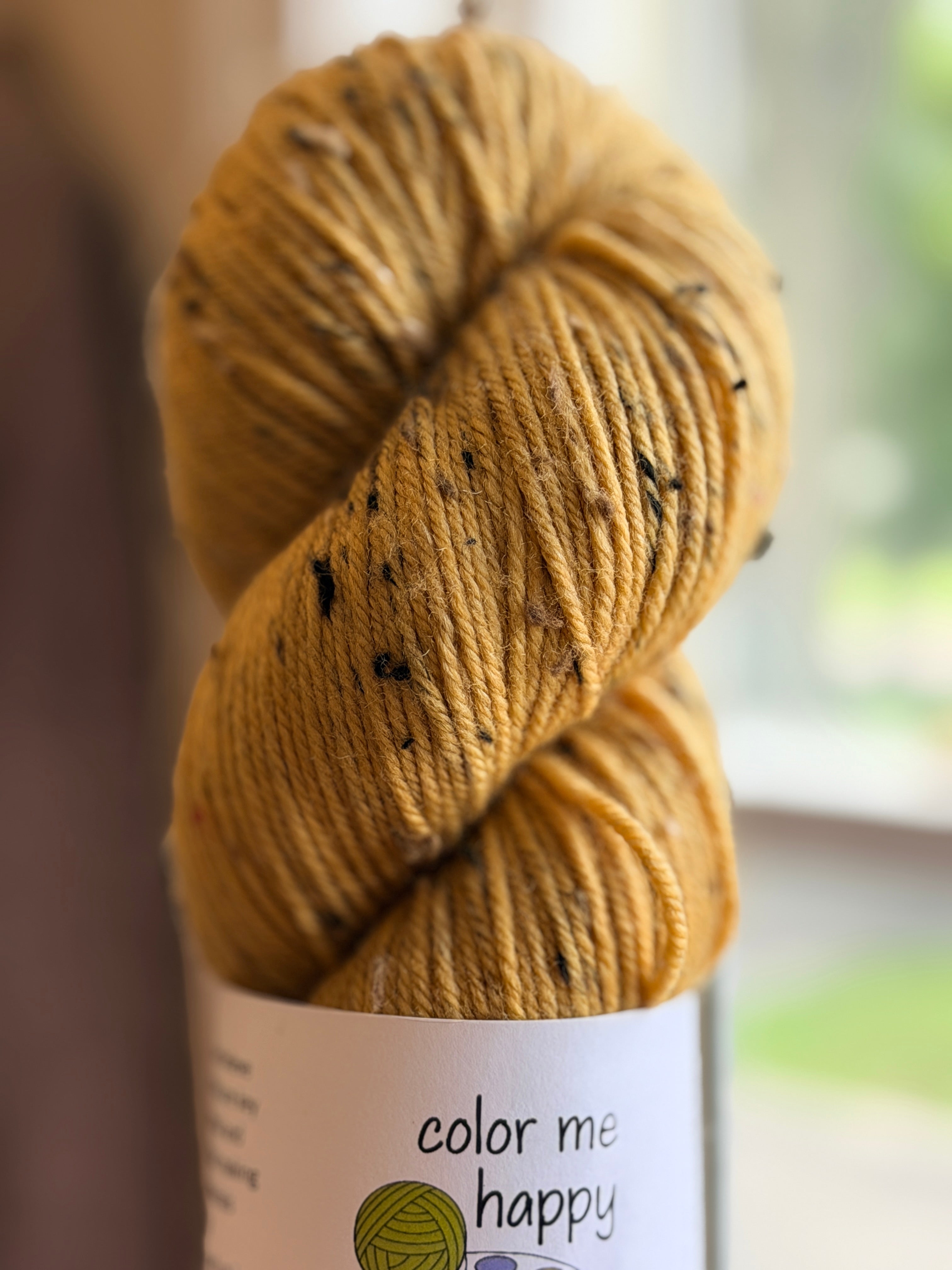 Yellow tweed yarn in natural light