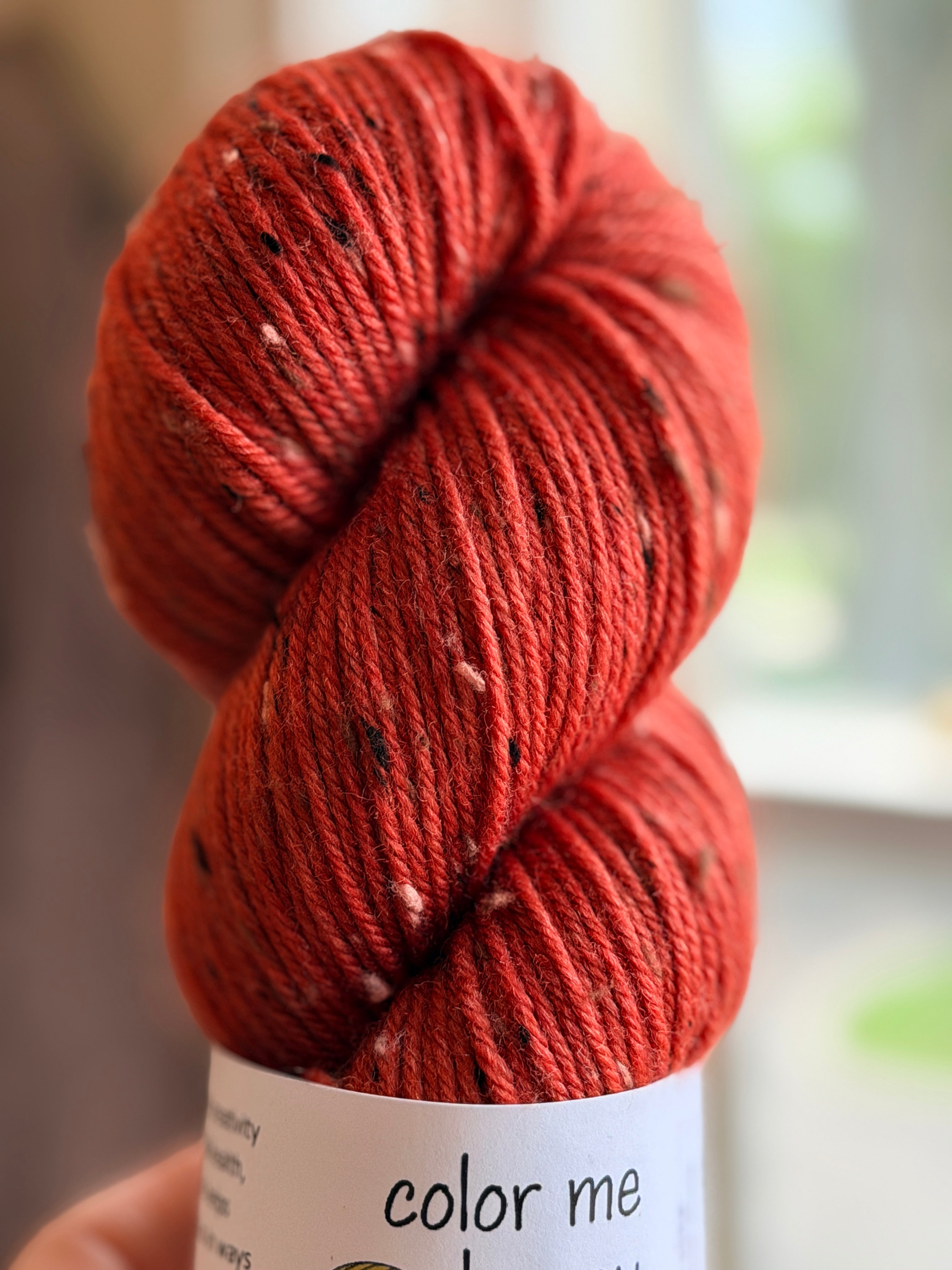 Orange tweed yarn in natural light
