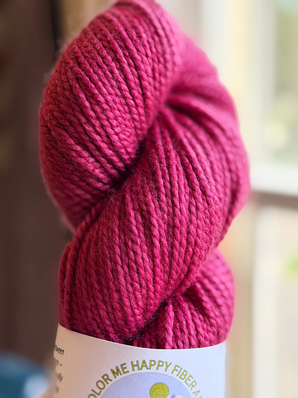 Dark pink yarn in natural light