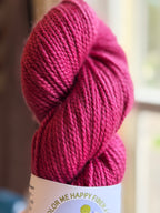 Dark pink yarn in natural light