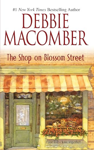 Book cover for 'The Shop on Blossom Street' by Debbie Macomber, featuring a storefront illustration with a green door, striped awning, and warm-toned window display.