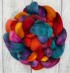 Multicolored  braid of Targhee fiber on a light wooden surface