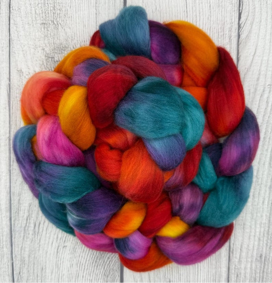 Multicolored  braid of Targhee fiber on a light wooden surface