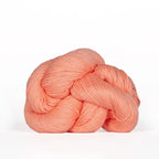 Peach-colored skein of yarn on a white background